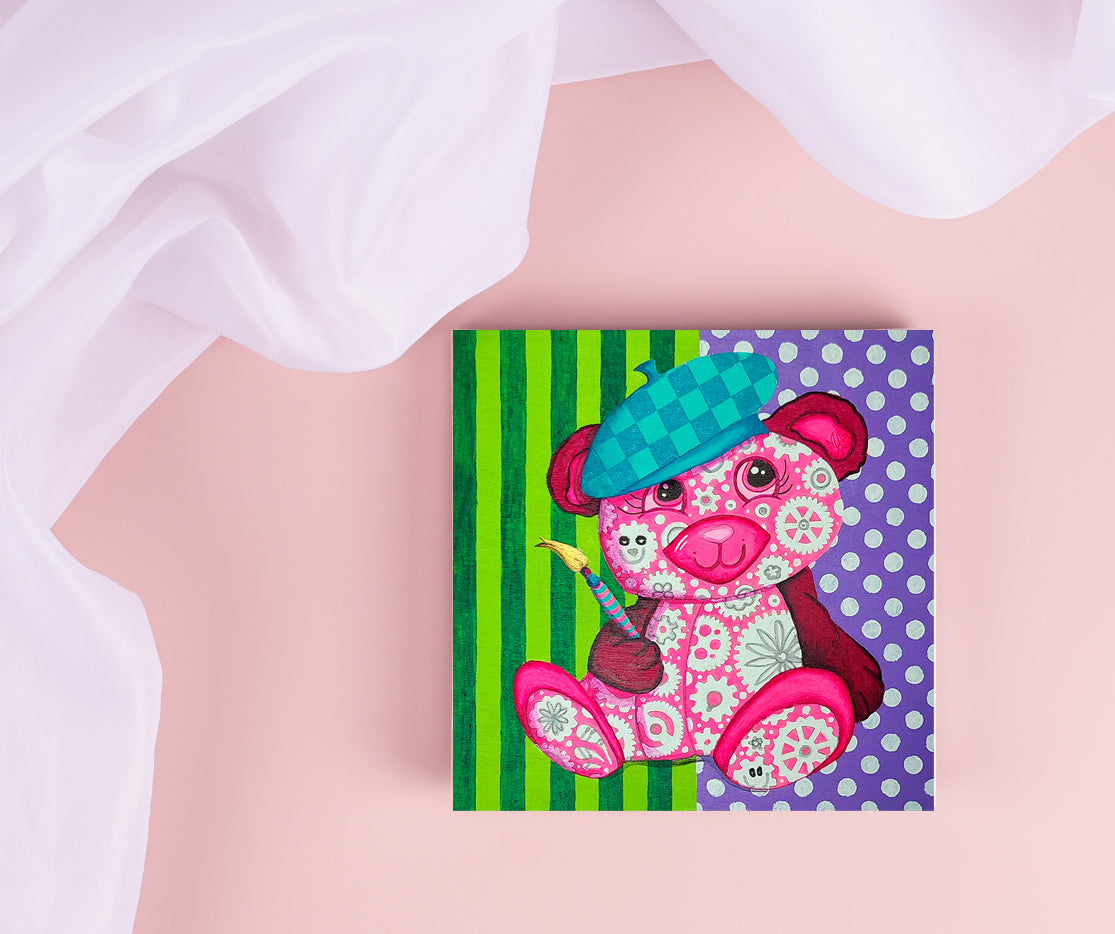 Meet Artisia, the GEAR BEAR who started it all! With her magical paintbrush in hand, she will bring the first world of Geartopia to life: ArtLandia. This vibrant, ever-evolving land will be spun together by the constant motion of gears, symbolizing time, movement, and boundless creativity.

Artisia dreams of a world where imagination and art become a universal language. She inspires everyone she meets to pick up their own “paintbrush”—whether literal or figurative—and create something beautiful.